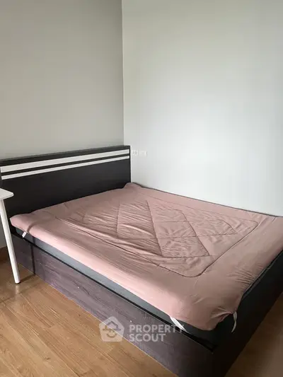 Modern bedroom with sleek wooden bed and minimalist design