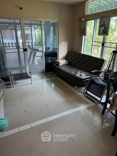 Spacious living room with modern furniture and large windows offering natural light.