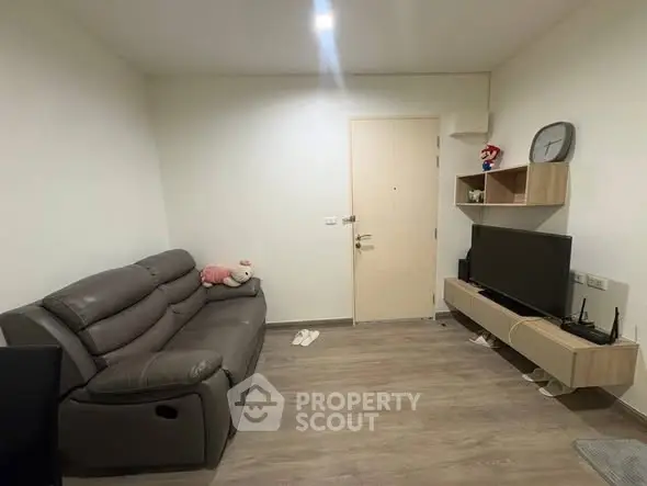 Cozy living room with modern sofa and wall-mounted TV unit