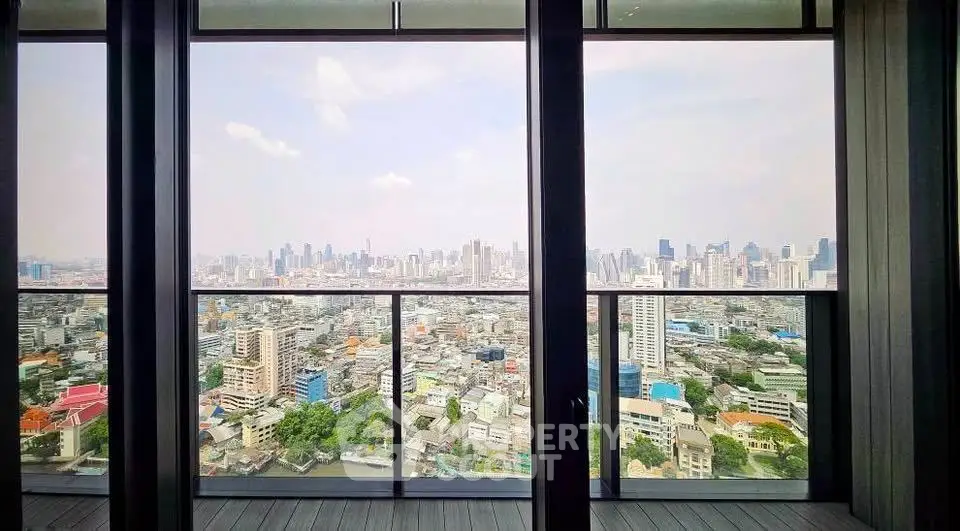 Stunning cityscape view from high-rise apartment balcony, showcasing urban skyline and vibrant city life.