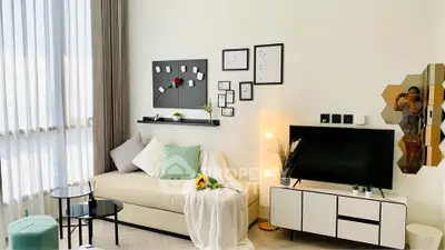 Stylish modern living room with cozy sofa, wall art, and TV unit, perfect for relaxation and entertainment.