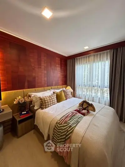 Cozy bedroom with stylish decor and large window for natural light