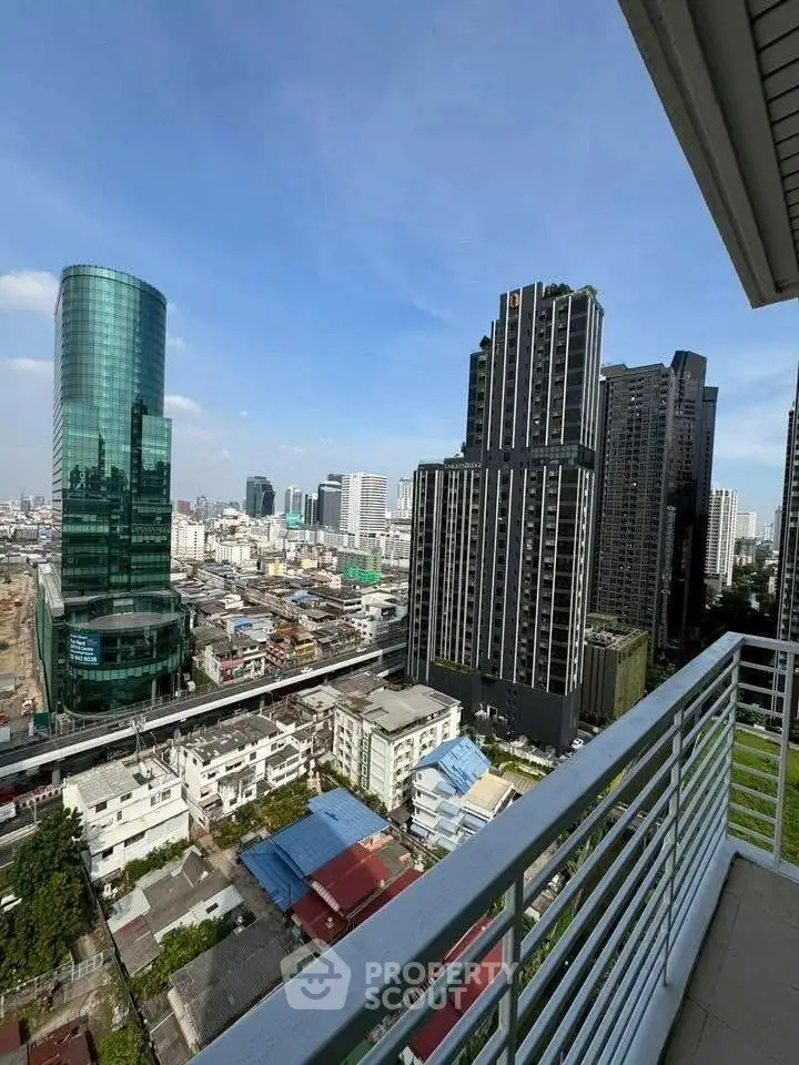 Stunning cityscape view from a high-rise balcony showcasing modern skyscrapers and urban landscape.