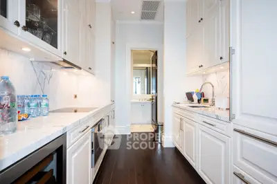 Luxurious kitchen with sleek cabinetry and modern appliances in a high-end home.