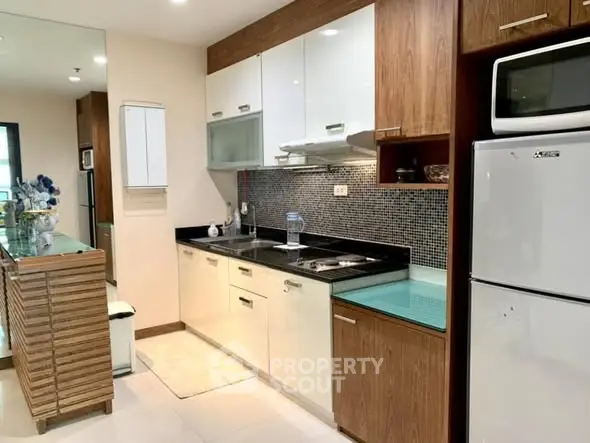 Modern kitchen with sleek cabinetry and built-in appliances in a stylish apartment.