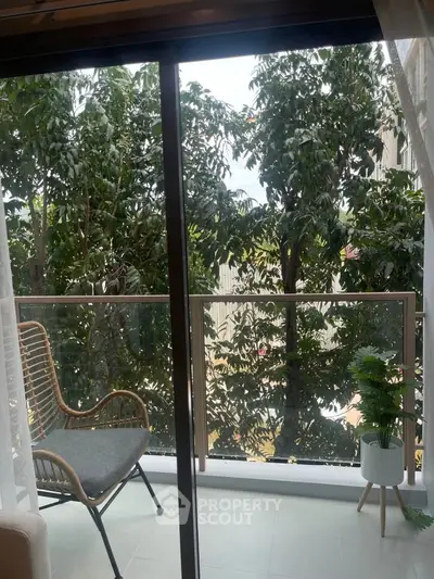 Charming balcony with lush greenery view, perfect for relaxation and enjoying nature.