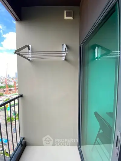 Modern balcony with city view and glass sliding door, perfect for urban living.