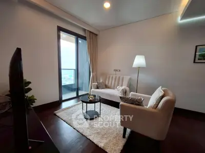 Elegant living room with cozy seating and balcony view in modern apartment