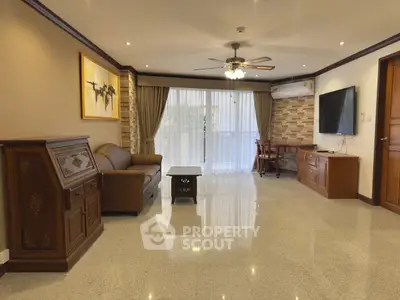 Spacious living room with elegant decor and large windows for natural light