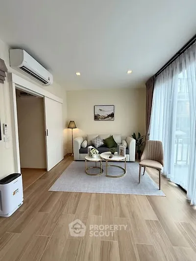 Modern living room with stylish decor and large windows for natural light.