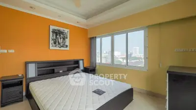 Spacious bedroom with city view and modern furnishings