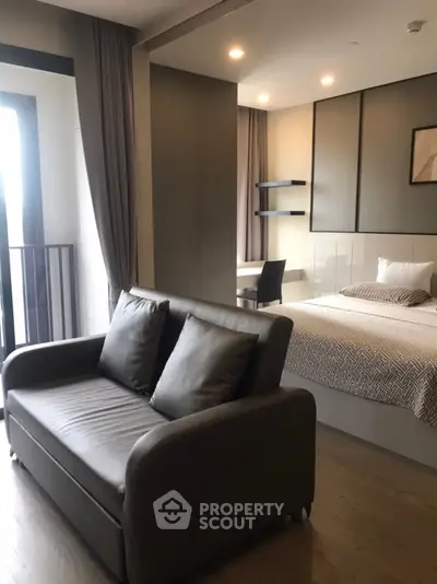 Modern studio apartment with cozy living area and stylish bedroom decor.