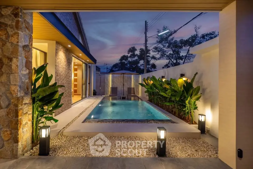 Luxurious private pool area with ambient lighting and lush greenery, perfect for relaxation and entertainment.