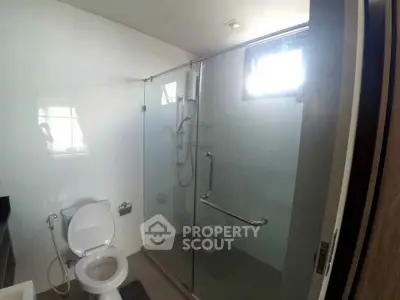 Modern bathroom with glass shower enclosure and sleek fixtures