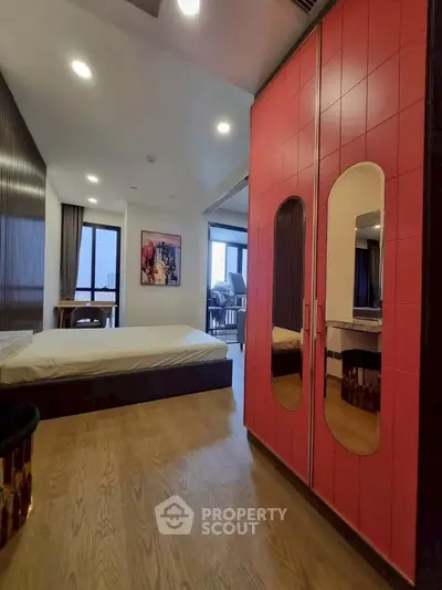 Modern bedroom with stylish red wardrobe and cozy decor