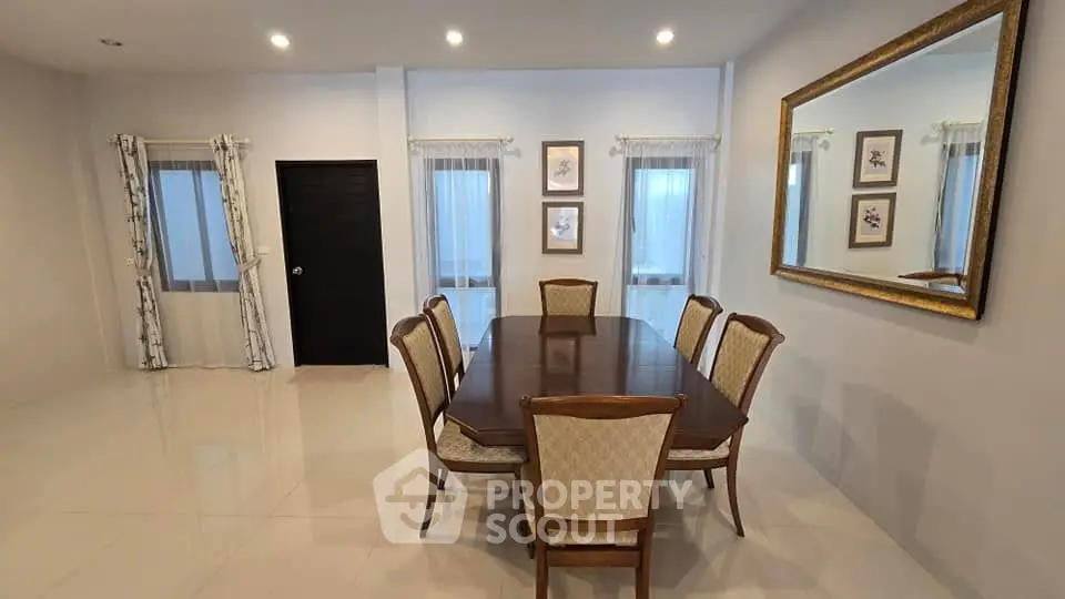 Elegant dining room with large mirror and classic wooden table set