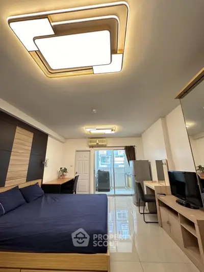 Modern bedroom with stylish lighting and sleek furniture in a contemporary apartment.