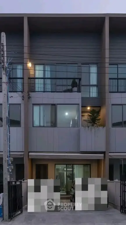 Modern townhouse exterior with sleek design and spacious balconies