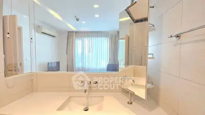 Modern bathroom with sleek design and large mirror in a contemporary apartment.