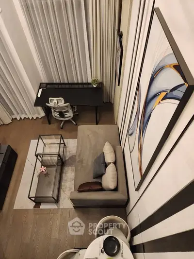 Modern living room with high ceilings, stylish decor, and a cozy seating area.