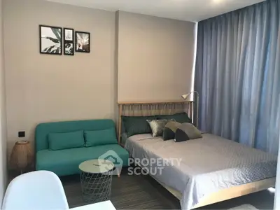 Modern bedroom with stylish decor and cozy seating area, perfect for relaxation and comfort.