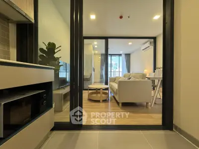 Modern living room with cozy furniture and open layout, featuring a stylish interior design.