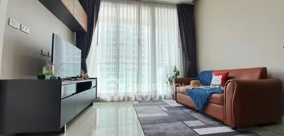 Modern living room with sleek furniture and large windows offering natural light.