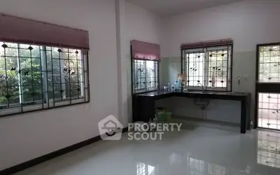 Spacious kitchen with large windows and sleek countertops