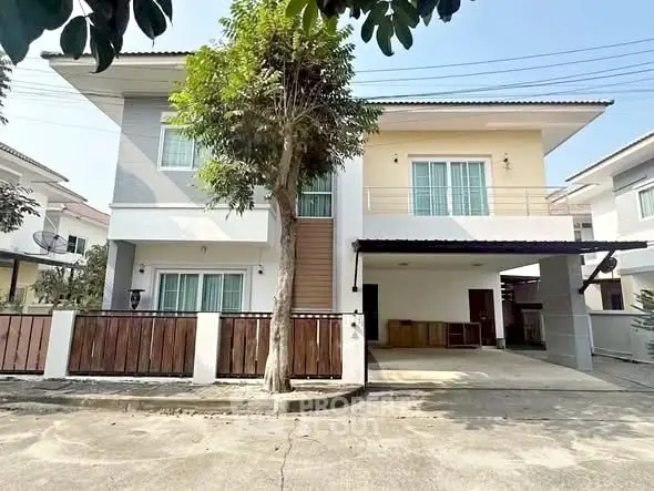 Modern two-story house with spacious driveway and contemporary design in a suburban neighborhood.
