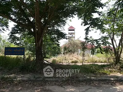 Abandoned clubhouse with overgrown vegetation and a distant tower, hinting at potential for renovation.