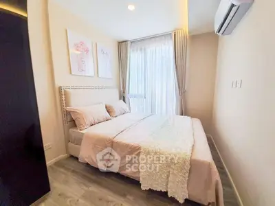 Cozy bedroom with elegant decor and natural light in modern apartment.