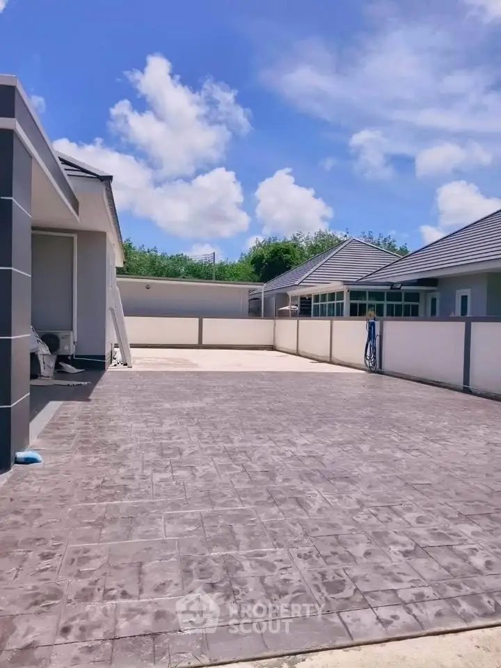 Spacious modern driveway with elegant paving in a serene residential neighborhood.