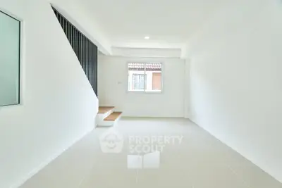 Spacious minimalist interior with sleek staircase and bright natural light