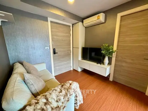 Cozy living room with modern decor and air conditioning in a stylish apartment.