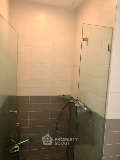 Modern bathroom with glass shower enclosure and sleek tile design