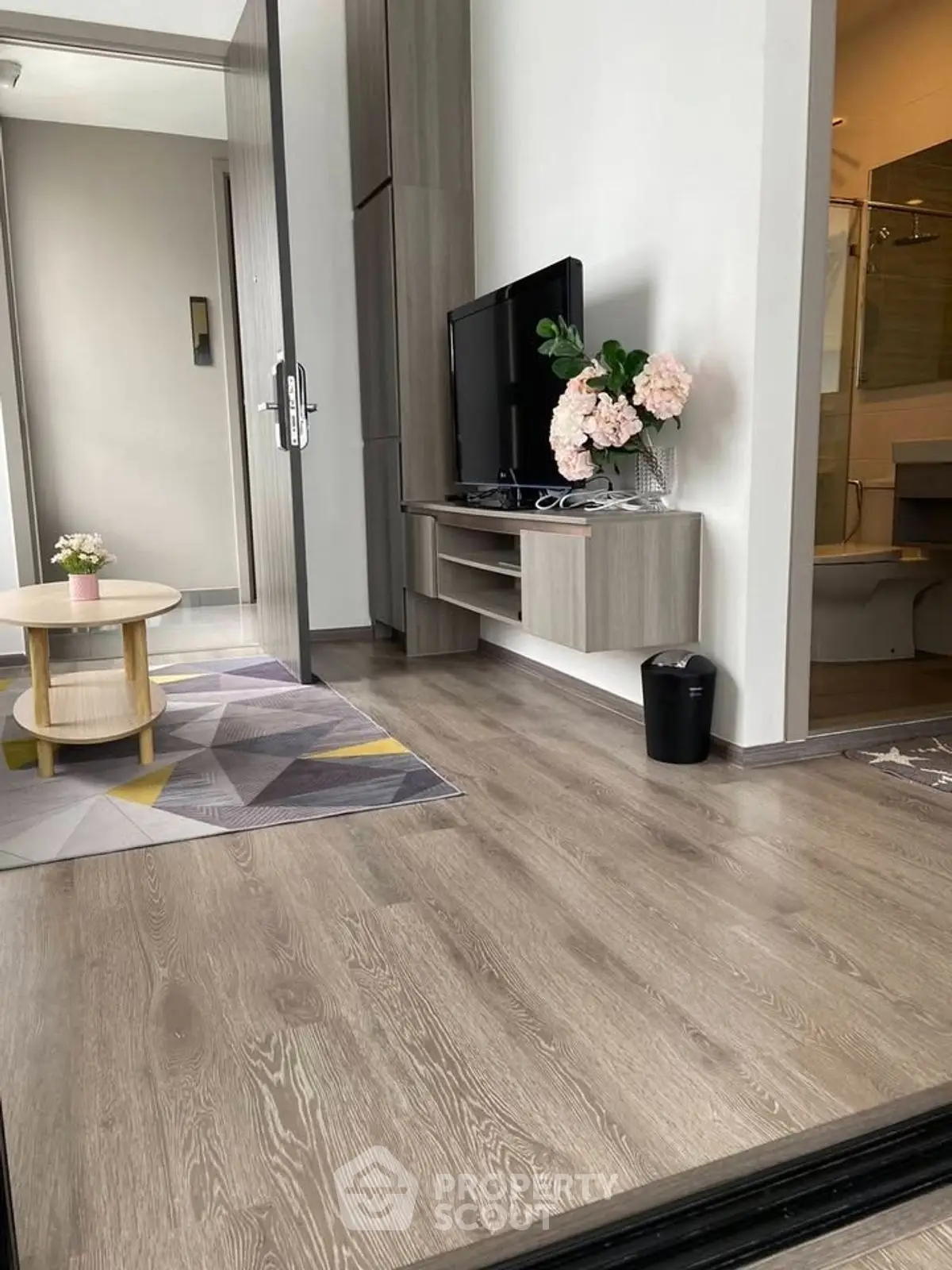 Modern living room with sleek wooden flooring and stylish decor