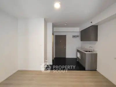 Modern apartment interior with open kitchen layout and sleek cabinetry