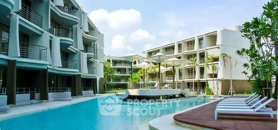 Luxurious resort-style apartment complex with stunning pool and modern architecture.