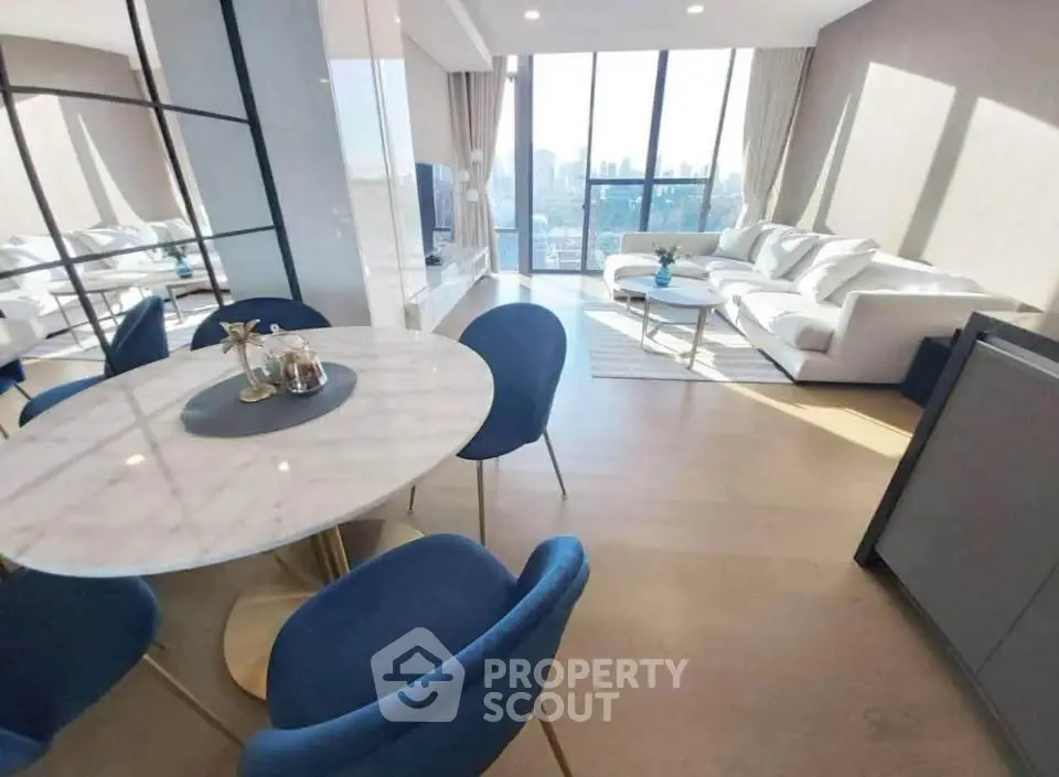 Luxurious modern living room with city view, elegant furniture, and abundant natural light.