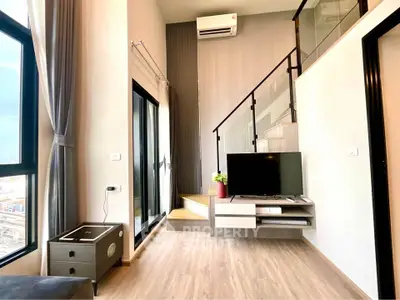 Modern duplex living room with stylish decor and large windows