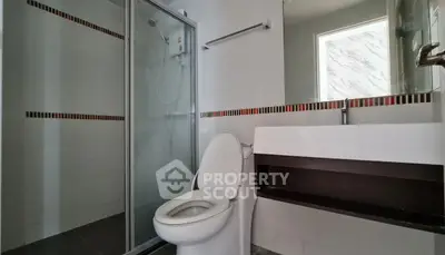Modern bathroom with glass shower and sleek fixtures