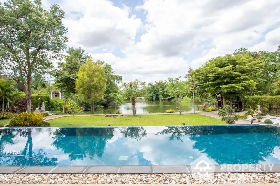 Stunning backyard with luxurious pool and serene lake view, perfect for relaxation and entertaining.