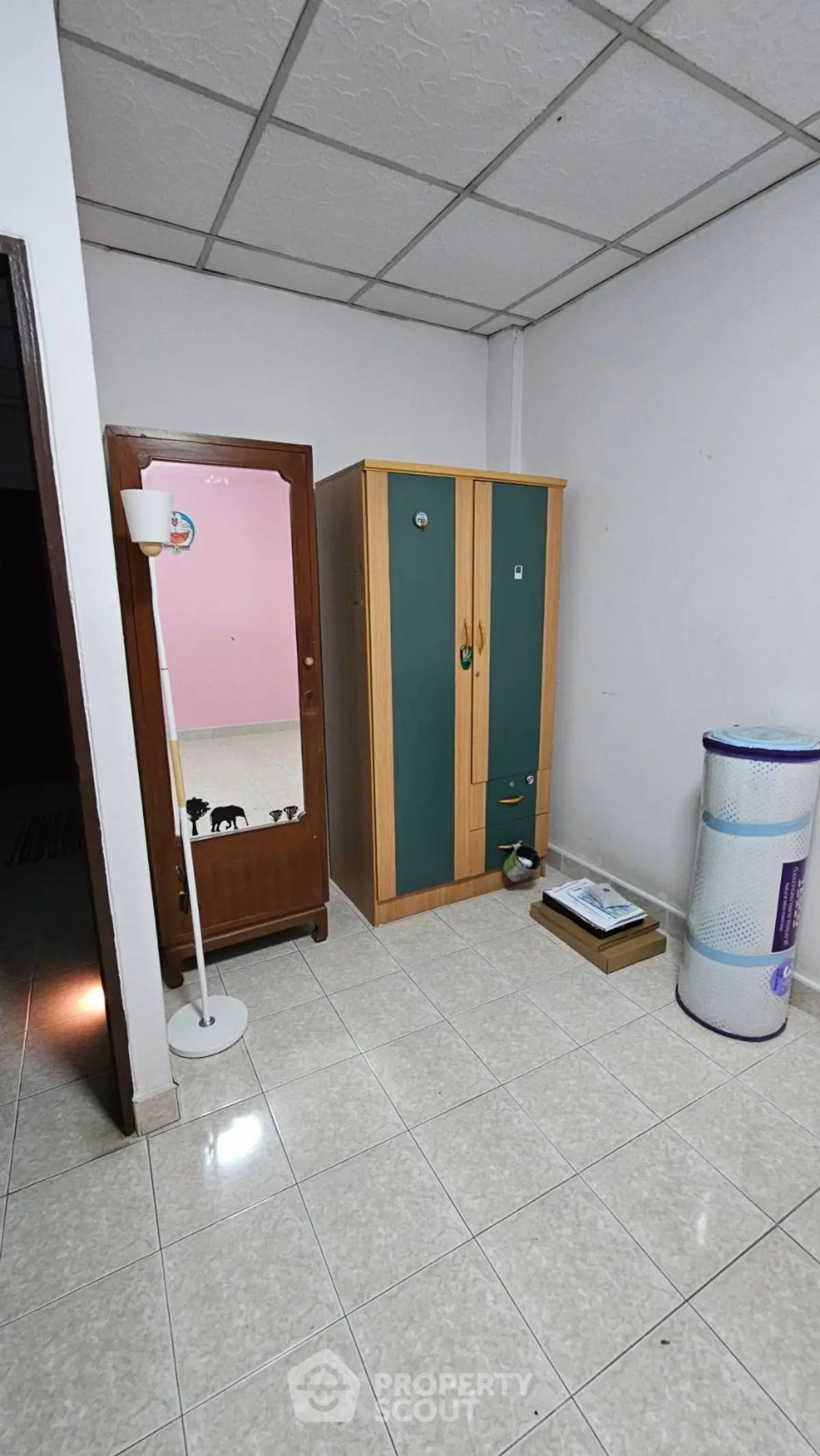 Spacious room with wardrobe and mirror, ideal for storage or utility use.