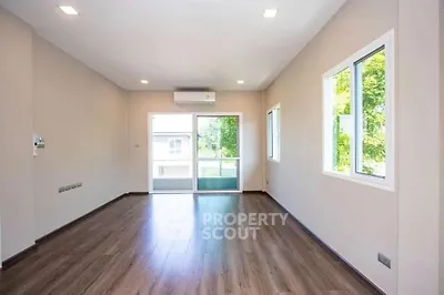 Spacious empty living room with large windows and wooden flooring