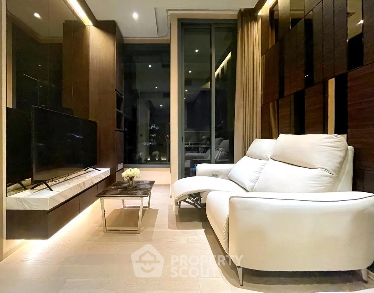Luxurious modern living room with sleek design and large TV, perfect for relaxation and entertainment.