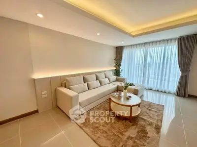 Spacious modern living room with elegant decor and large windows