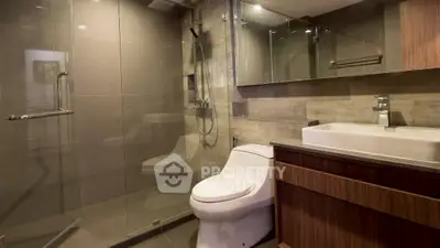 Modern bathroom with glass shower and sleek fixtures