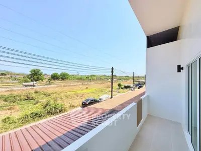 Spacious balcony with scenic countryside view, perfect for relaxation and enjoying nature.