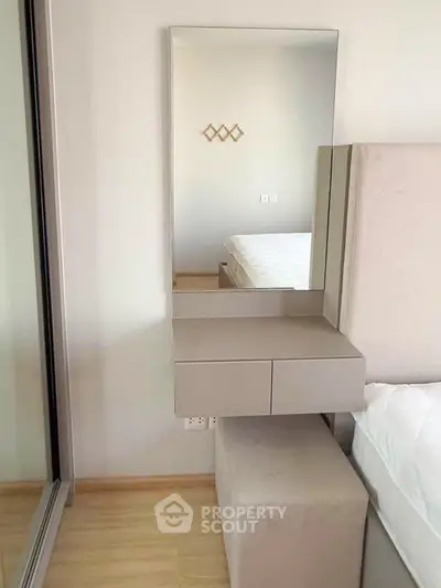 Modern bedroom with stylish mirror and sleek furniture design