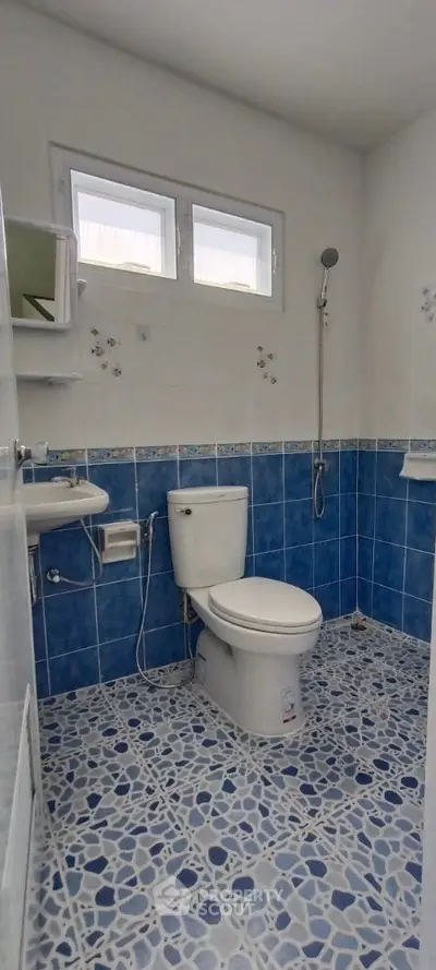 Charming bathroom with blue tile accents and modern fixtures